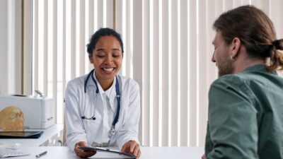 A doctor talking with a patient in a bright clinic