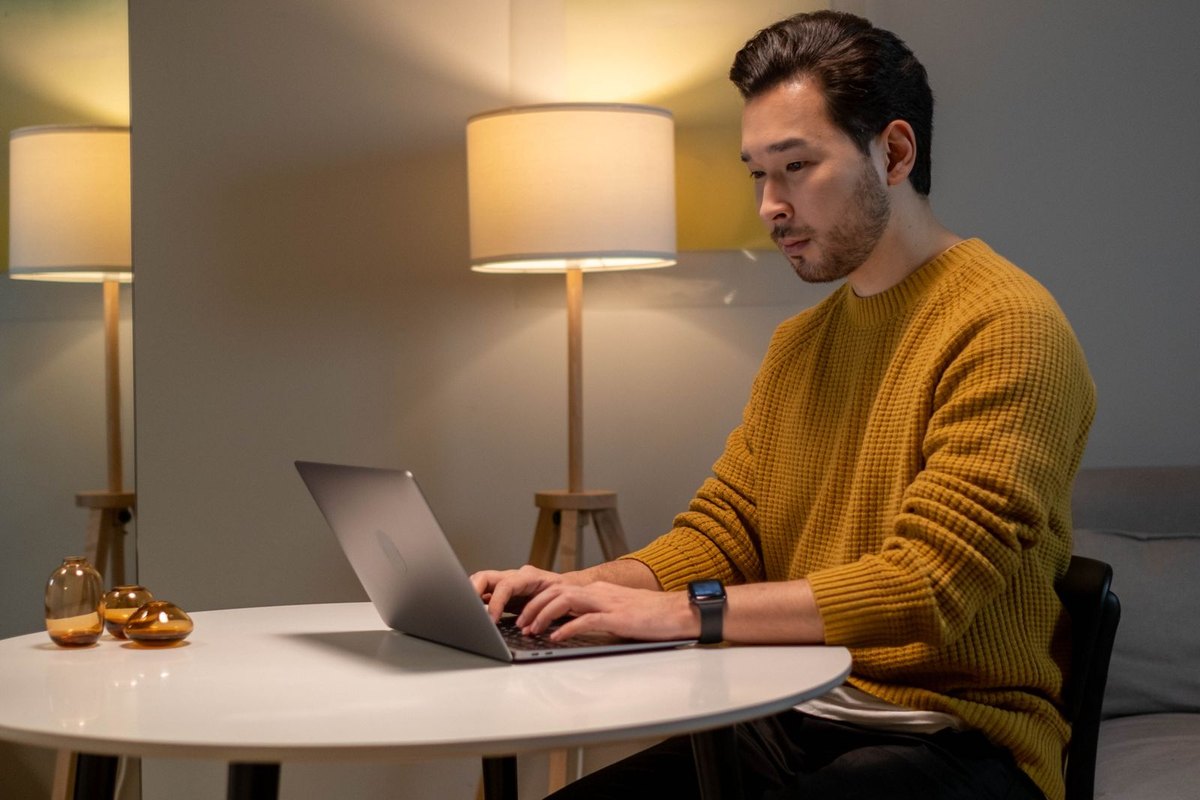 A man working on a laptop in his living room