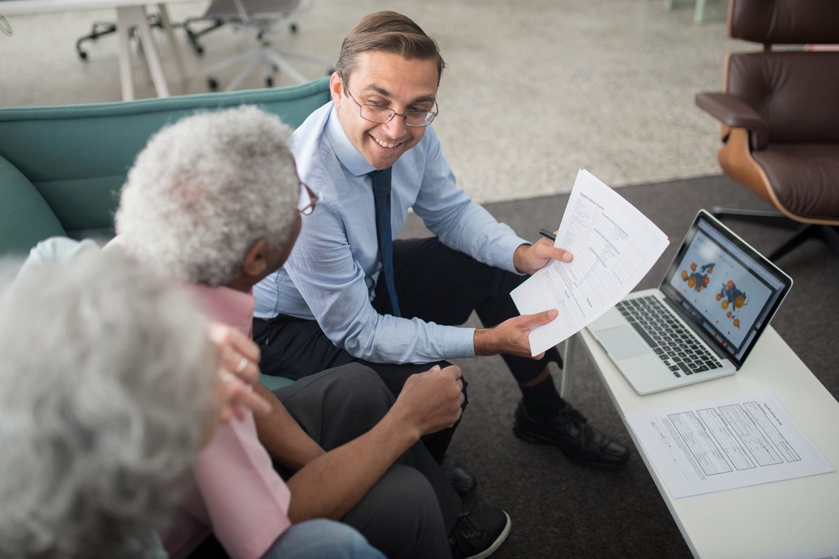 An adviser going through documents with an older man
