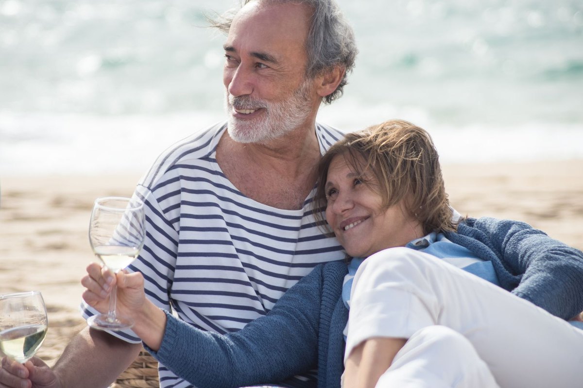 An older couple relaxing on a beach